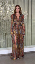 Full front view of model wearing Rust Multi metallic plissé long sleeve cutout maxi gown