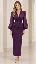 Front view of model wearing deep purple pleated peplum maxi dress with sheer sleeves