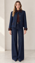 Front view of model wearing Indigo Blue denim jacket and wide-leg pant set with brown contrast trim
