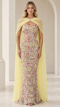 Pastel yellow floral embroidered strapless evening gown with sheer chiffon capelet front view