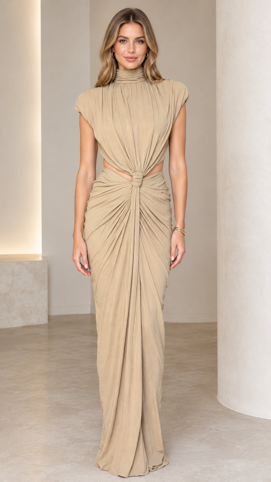 Front full-length view of woman wearing beige high neck cutout draped maxi dress