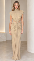 Front full-length view of woman wearing beige high neck cutout draped maxi dress