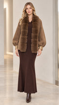 Front view of woman wearing camel faux fur trim short coat with maxi dress