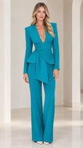 Front view of woman wearing teal deep V-neck blazer with pleated waist drape and wide-leg trousers