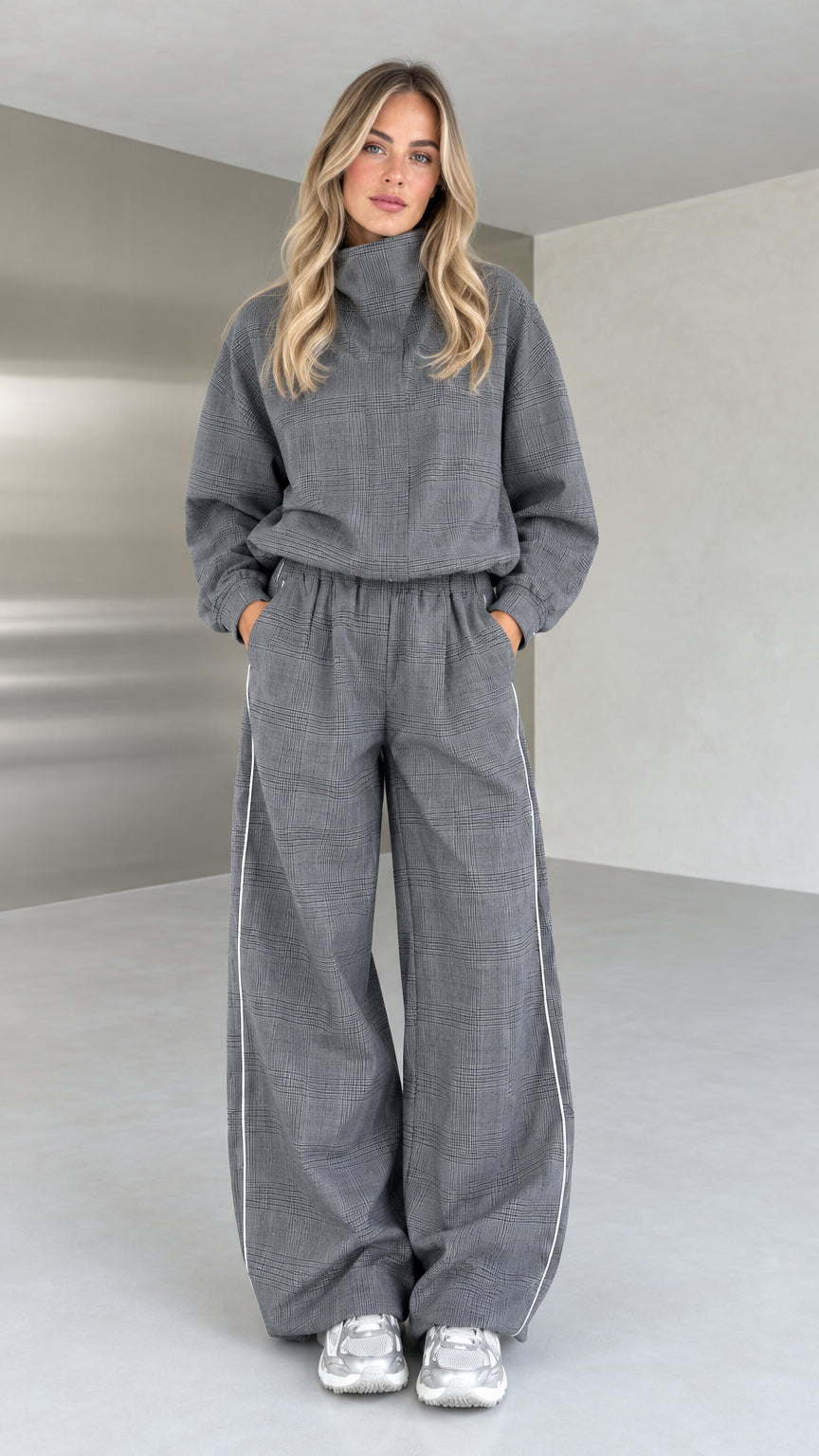 Full front view of model wearing grey plaid high-neck top and wide-leg pants set