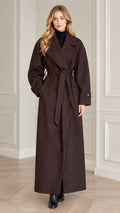 Full front view of model wearing dark brown maxi belted trench overcoat