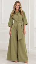 Full-length front view of woman wearing an olive green wide-leg collared jumpsuit with tie belt