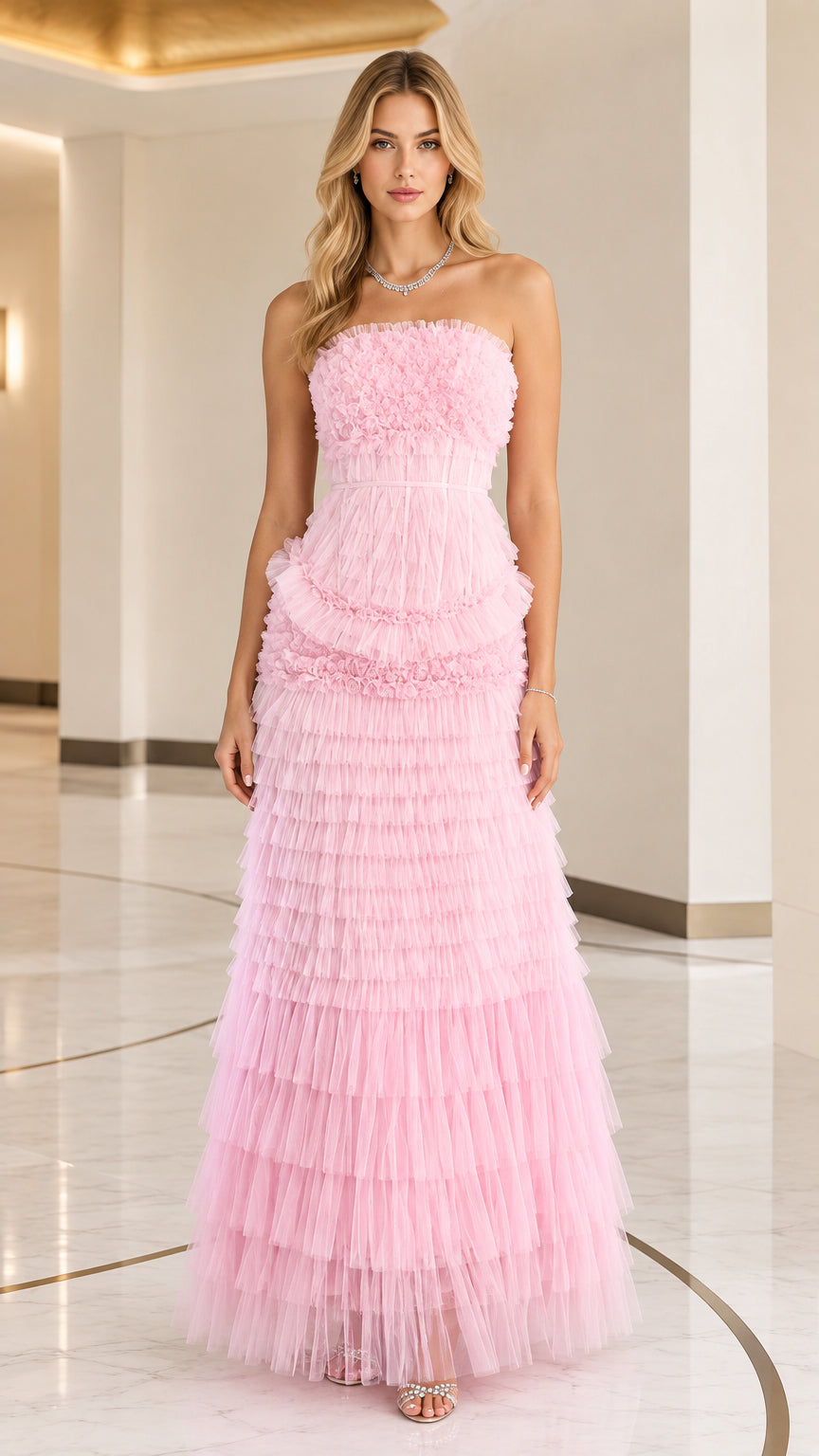 Front full view of woman wearing strapless pink tiered ruffle tulle evening maxi gown