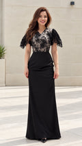 Front view of model wearing black floral lace flutter sleeve maxi evening gown