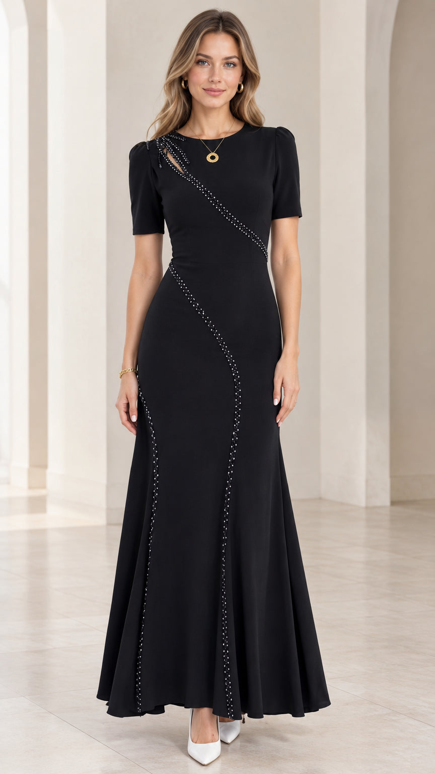 Front full-length view of woman wearing black beaded cutout mermaid maxi evening dress