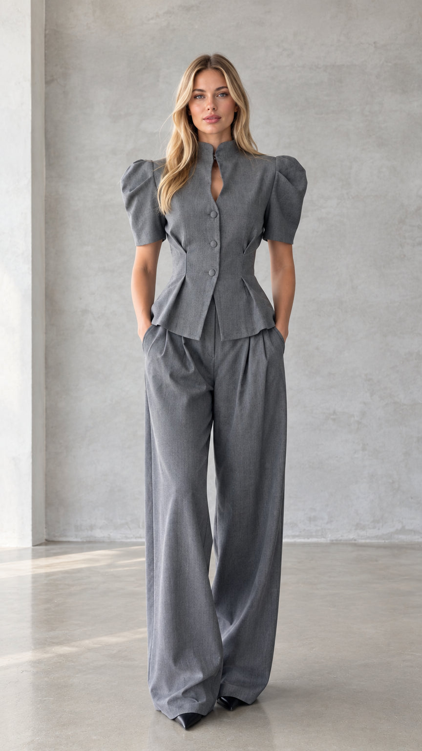Model wearing grey puff sleeve peplum top and matching wide leg pants set front view