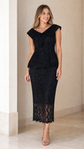 Front view of model wearing black floral lace peplum midi dress with folded collar