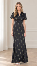 Front view of model wearing black floral print maxi dress with pleated waist and puff sleeves