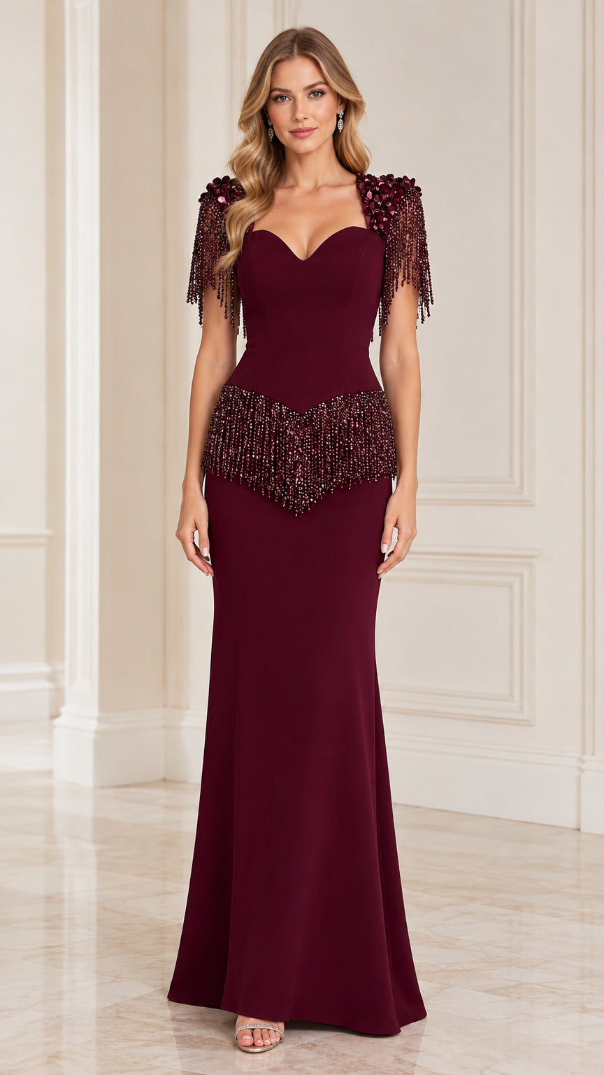Front view of model wearing burgundy sweetheart evening gown with beaded fringe shoulders and waist
