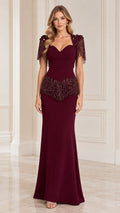 Front view of model wearing burgundy sweetheart evening gown with beaded fringe shoulders and waist
