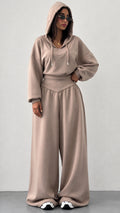 Front view of woman wearing taupe hooded sweatshirt and wide leg sweatpants lounge set