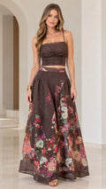 Front full view of woman wearing chocolate brown floral ruched crop top and maxi skirt set
