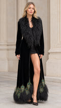 Front view of black velvet maxi evening coat with feather collar and peacock hem trim