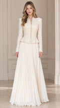Front full view of woman wearing ivory cream embellished peplum jacket and pleated maxi skirt formal set