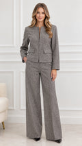 Front view of model wearing Grey textured tweed collarless jacket and wide leg pants suit