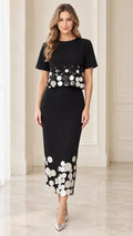 Front view of black short-sleeve midi dress with metallic disc embellishments