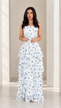Front view of model wearing white floral tiered spaghetti strap maxi dress