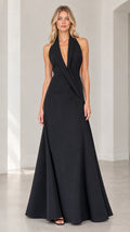Front view of black halter tuxedo lapel backless evening gown on model