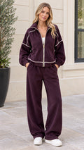 Front full view of woman wearing burgundy ribbed corduroy zip jacket and wide leg pants set
