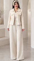 Full front view of model wearing the cream pearl-trimmed tweed jacket and matching wide-leg pants set