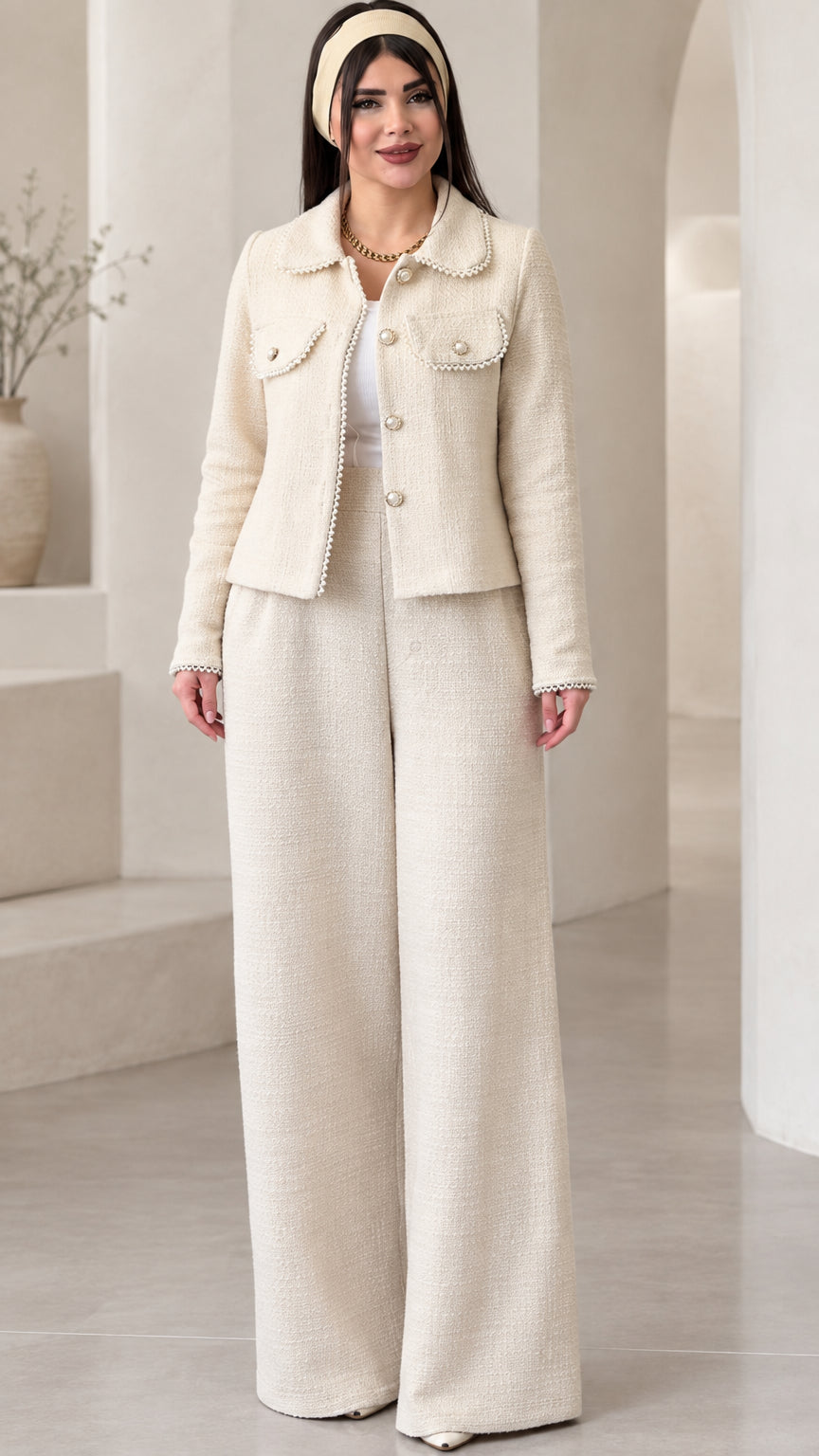 Full front view of model wearing the cream pearl-trimmed tweed jacket and matching wide-leg pants set
