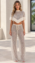 Front full view of woman wearing Champagne sequin fringe crop top and wide leg pants set