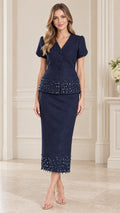 Front full-length view of woman wearing navy blue beaded trim short sleeve skirt suit set