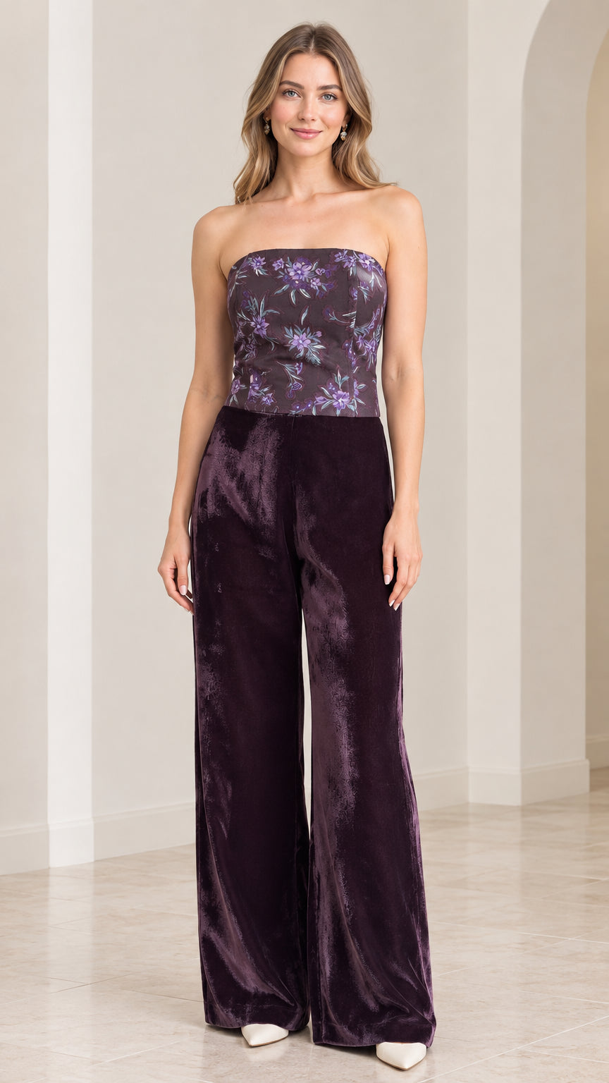 Front view of woman wearing strapless plum purple floral velvet wide leg jumpsuit