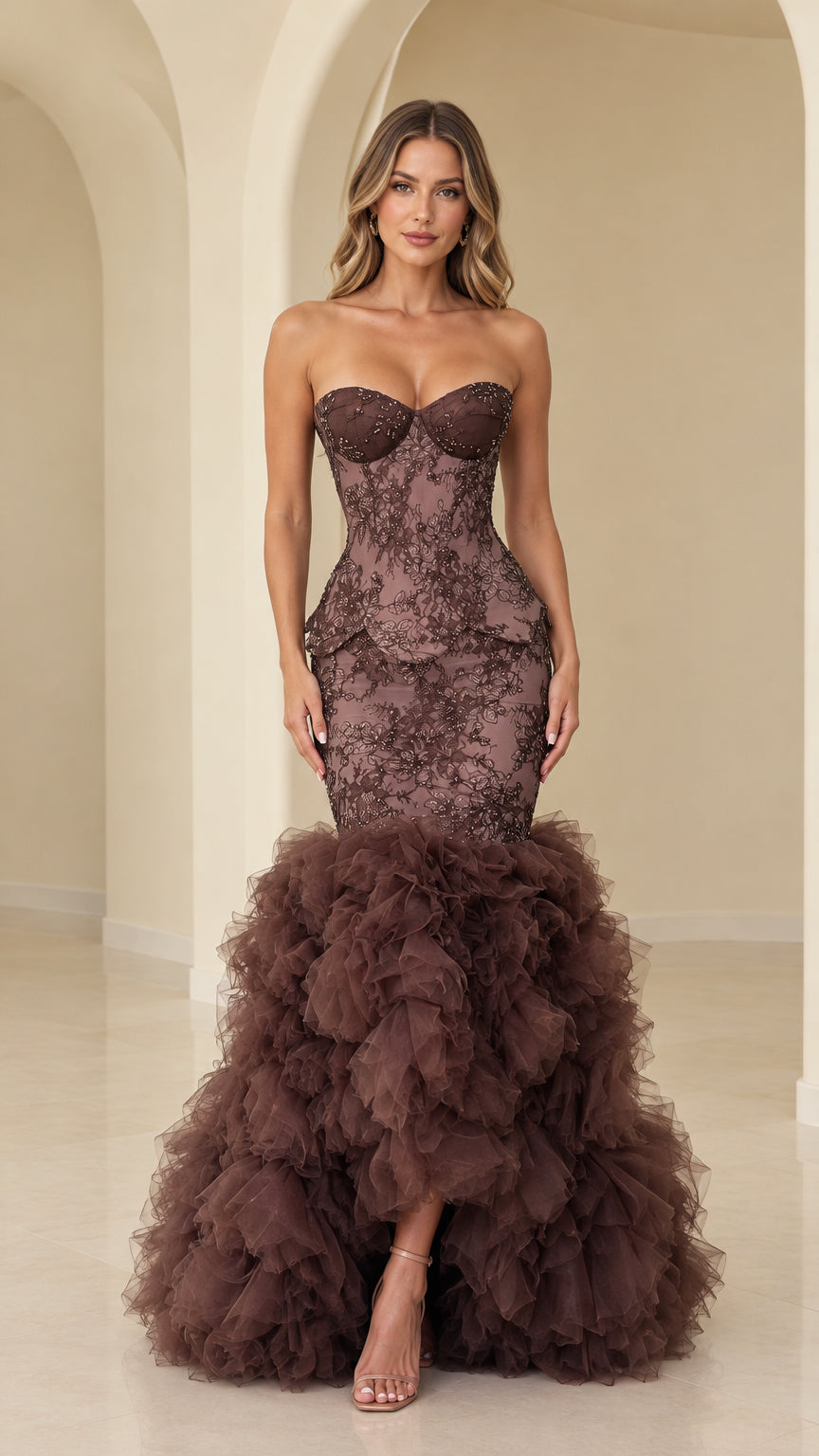 Front view of model wearing chocolate brown strapless beaded lace mermaid gown with tiered ruffle skirt