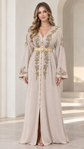 Front view of model wearing beige embroidered caftan maxi dress with gold belt