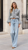 Model wearing silver cropped sequin tweed fringe jacket with wide-leg jeans, front view