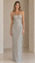 Front view of model wearing a strapless silver beaded fringe evening gown