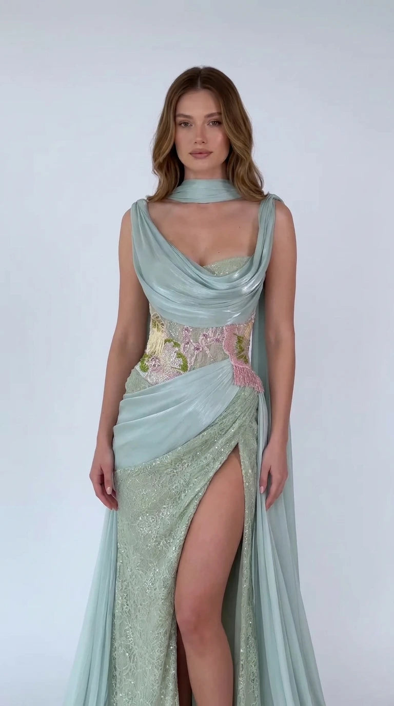 Front view of model wearing Sage Green draped cowl neck cape evening gown with slit