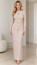 Front view of champagne long sleeve embellished maxi column dress