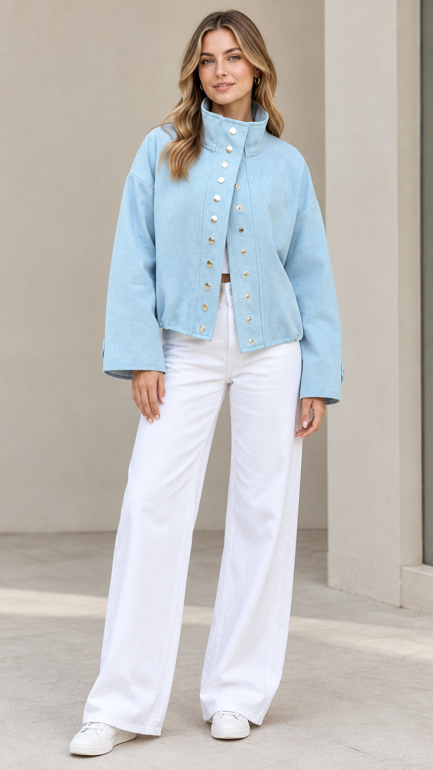 Front full-length view of woman wearing Light Blue stand collar snap jacket and white wide-leg trousers
