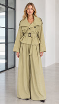 Front full view of woman wearing sage green belted trench jacket and wide-leg pant suit set