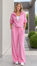 Full front view of model wearing pink zip-up jacket and wide leg pants tracksuit set