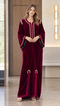 Full front view of model wearing a Burgundy velvet kaftan maxi dress with gold braided embroidery