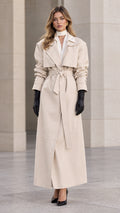 Front full-length view of woman wearing elegant cream maxi belted trench coat