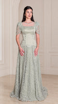 Front view of model wearing Sage Green beaded short sleeve evening gown