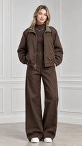 Front view of model wearing brown contrast collar zip jacket and matching wide leg pants