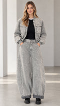 Full front view of model wearing grey acid wash denim bomber jacket and wide leg pants set