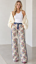 Front full view of woman wearing Cream Floral wide-leg pants with denim waistband