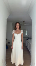 Front view of model wearing white lace cap-sleeve corset maxi dress