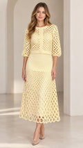 Pale yellow openwork crochet cardigan and midi skirt two-piece set on model